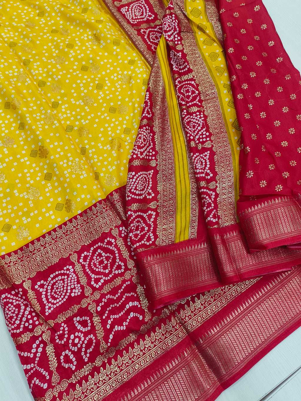 Yellow Red Semi Dola Silk With Bandhini Print And Foil Print Contrast Border And Rich Pallu Printed Blouse With Border