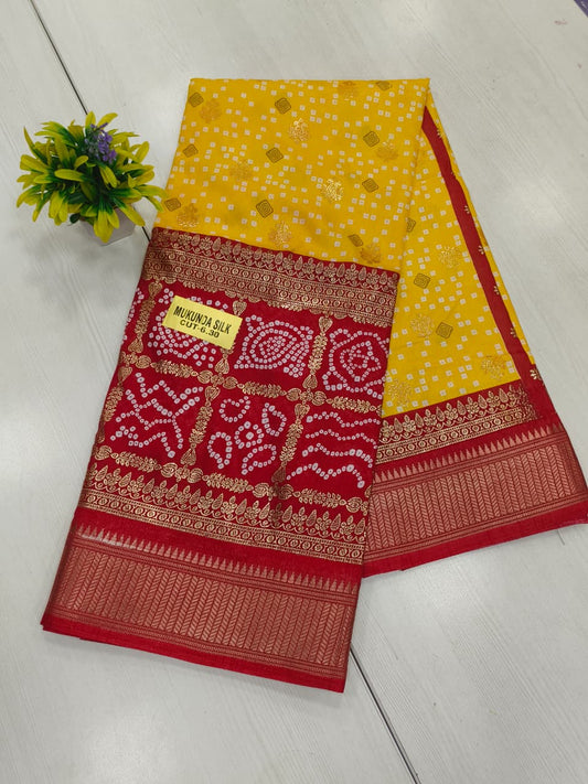 Yellow red Semi dola silk with bandhini print and foil print contrast border and rich pallu printed blouse with border